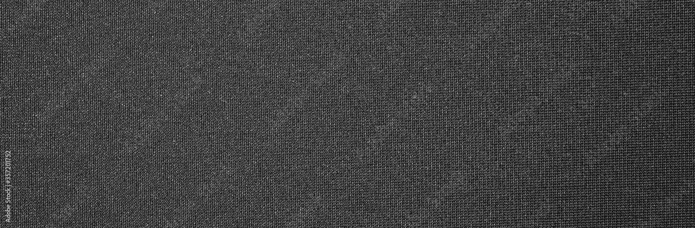 Texture of dense black fabric.Dark grey braided background. Texture of dense black fabric.Dark grey braided background.