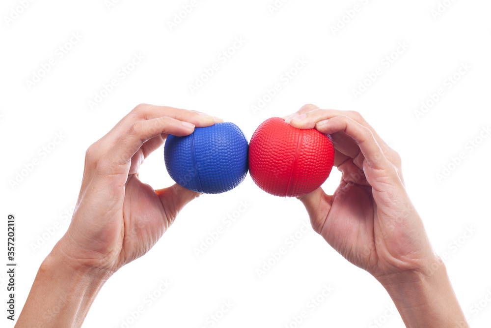 Hands of a woman squeezing a blue stress ball, isolated and white background Hands of a woman squeezing a blue stress ball, isolated and white background