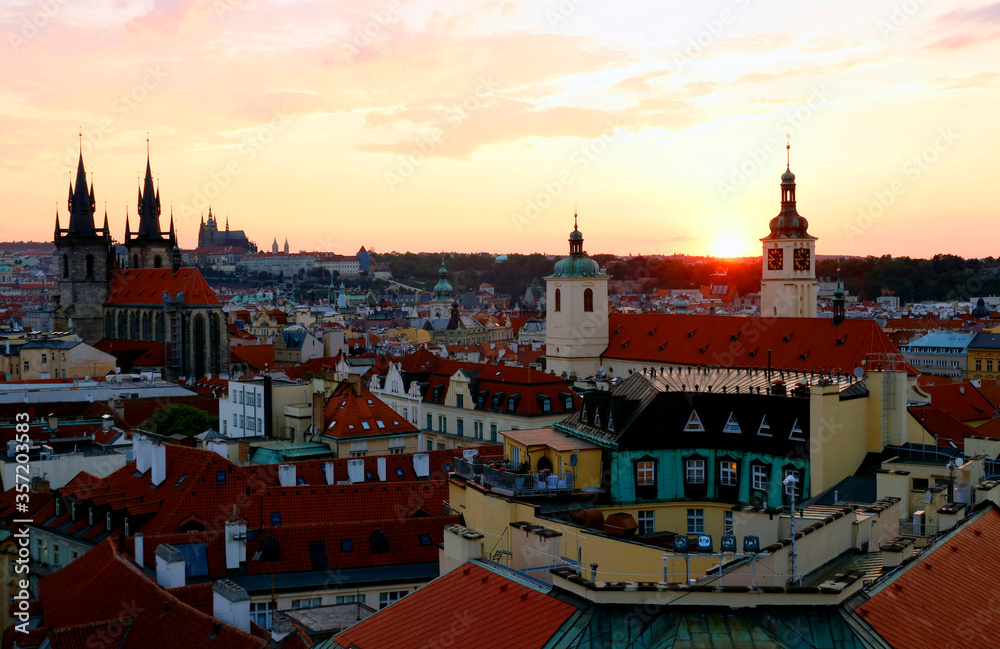 Obraz premium Most Prague through the eyes of birds with magnificent sunset and sky over the traditional houses with red roofs.