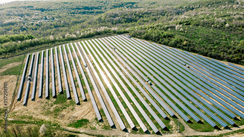 Solar panels at sunrise with cloudy sky in Normandy  France. Solar energy  modern electric power production technology  renewable energy concept. Environmentally friendly electricity production.