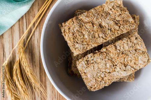 Cereal breakfast bars in breakfast bowl with wheat ears next to it