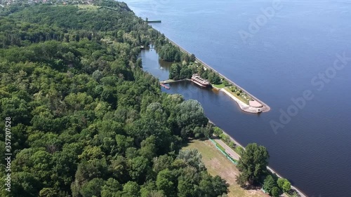 Aerial view. A large exotic wooden ship is located near the shore. Green lagoon. Kiev, Mezhyhirya. Drone