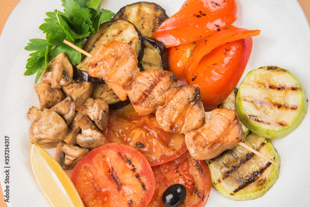 Grilled vegetables . Chicken kebab. Grilled vegetables on a white plate Grilled vegetables . Chicken kebab. Grilled vegetables on a white plate