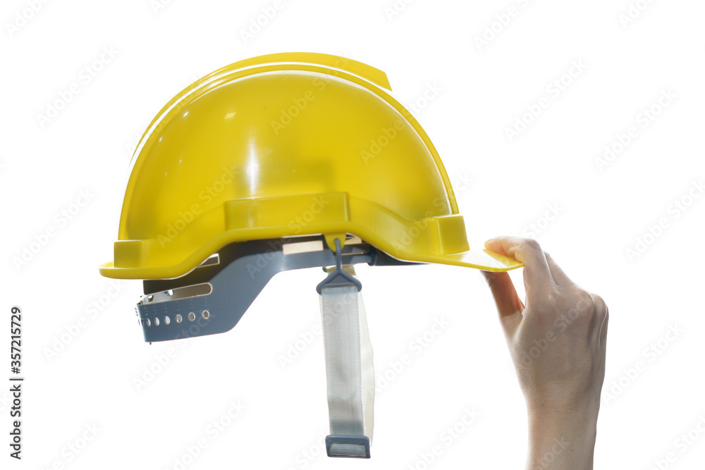 Woman hand holding yellow safety helmet isolated on white background. Woman hand holding yellow safety helmet isolated on white background.