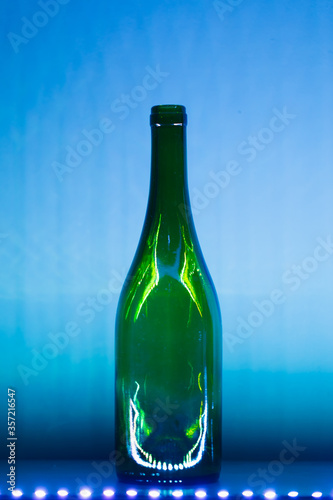 abstract empty wine bottle with blue led illumination