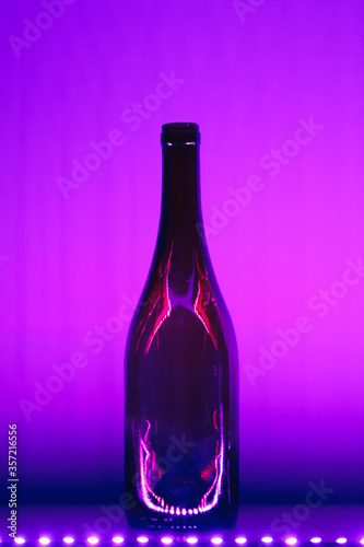 abstract empty wine bottle with purple led illumination