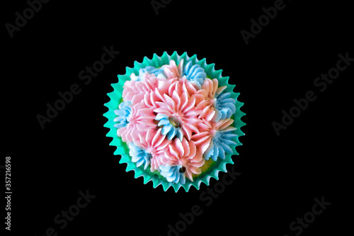 Pink and blue cupcake over black background