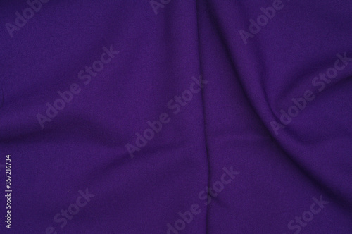 Creased purple gabardine. Rumpled texture. Folded fabric