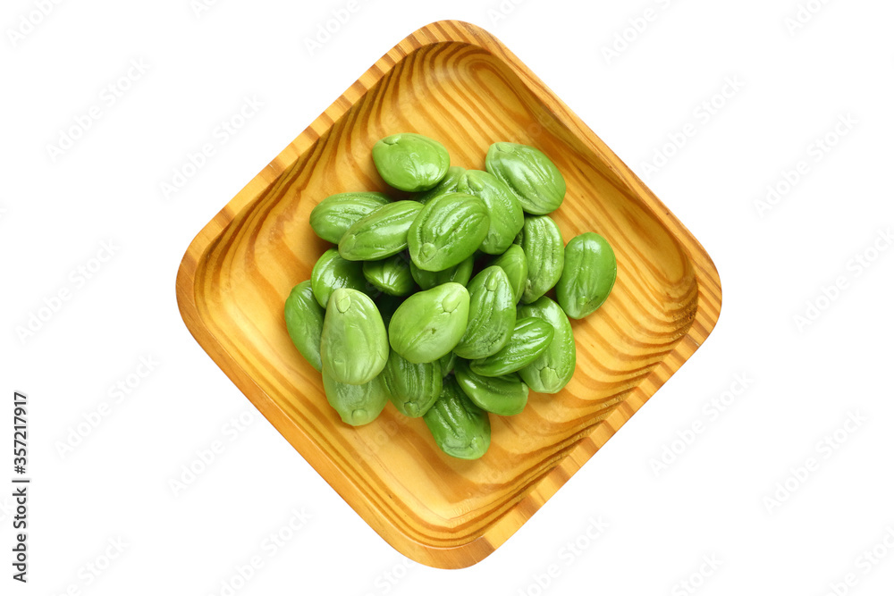Bitter bean, Twisted cluster bean or Stink bean in wood plate on white background. thai name is sator Bitter bean, Twisted cluster bean or Stink bean in wood plate on white background. thai name is sator