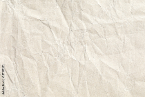 Pale crumpled yellow paper texture