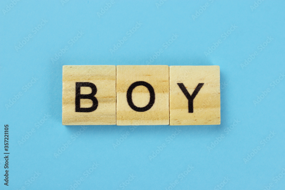 boy word of wooden letters on a blue background boy word of wooden letters on a blue background