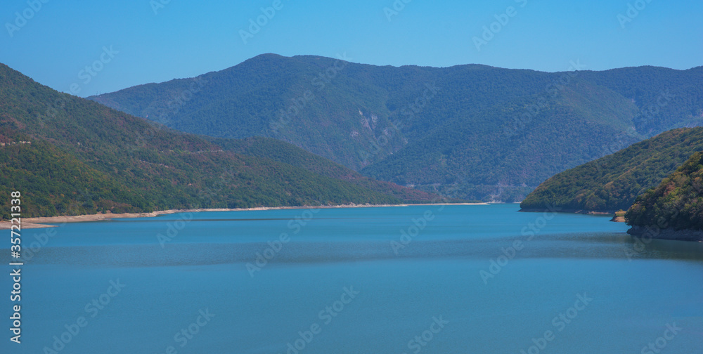 Mountain landscape, lake and mountain range in Georgia country. Autumn evening lake view. Beauty of nature concept background.