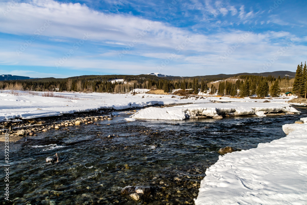 Water starting to peak through the river in late winter. Allan Bull Provincial Recreation Area. Alberta, Canada Water starting to peak through the river in late winter. Allan Bull Provincial Recreation Area. Alberta, Canada