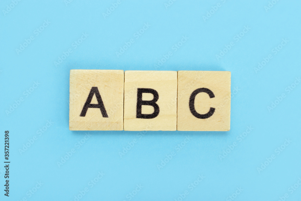 ABC word of wooden letters on a blue background ABC word of wooden letters on a blue background