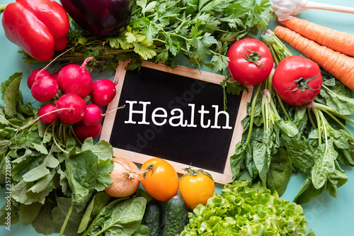Fresh vegetables around black desk with text 