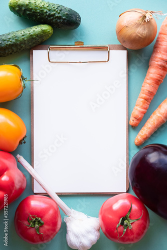 Small whiteboard with vegetables around. Copy space. Healthy concept