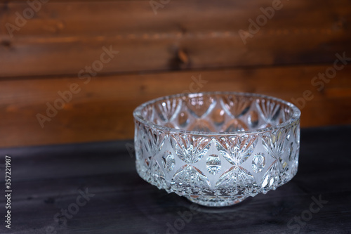 Crystal bowl on wooden background