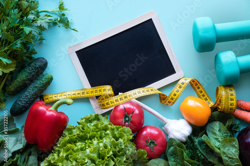 Diet. Fitness and healthy food diet concept. Balanced diet with vegetables on blue background