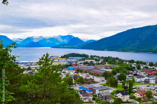 Scenic landscape Andalsnes city located on shores of Romsdal Fjord between the picturesque mountains. View from Rampestreken Viewpoint, Andalsnes, Norway.