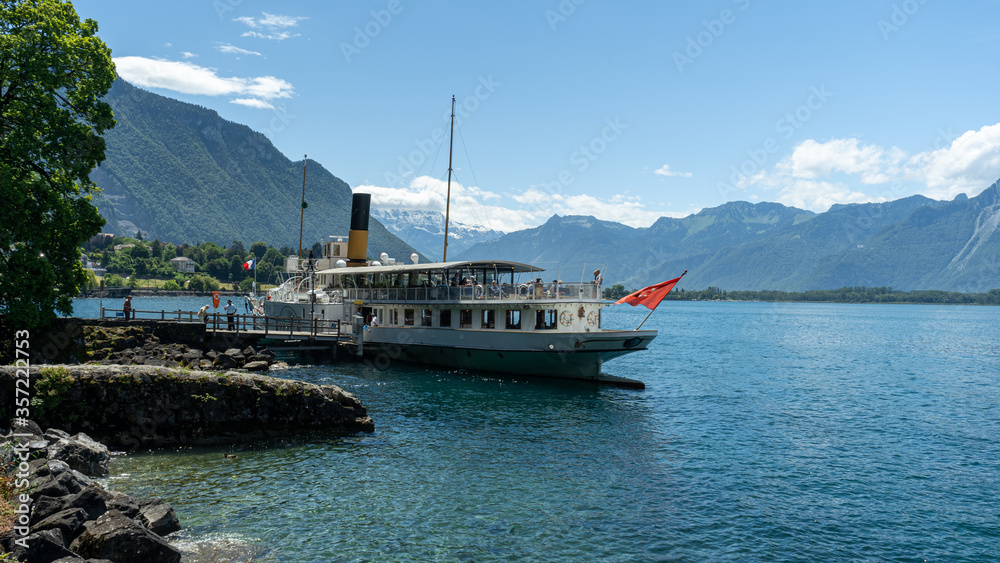 Swiss boat waiting for passengers at the Chillon's quay platform, 12 June 2020, Switzerland. Swiss boat waiting for passengers at the Chillon's quay platform, 12 June 2020, Switzerland.