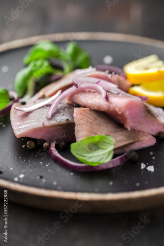 marinated herring with red onion, lemon and basil