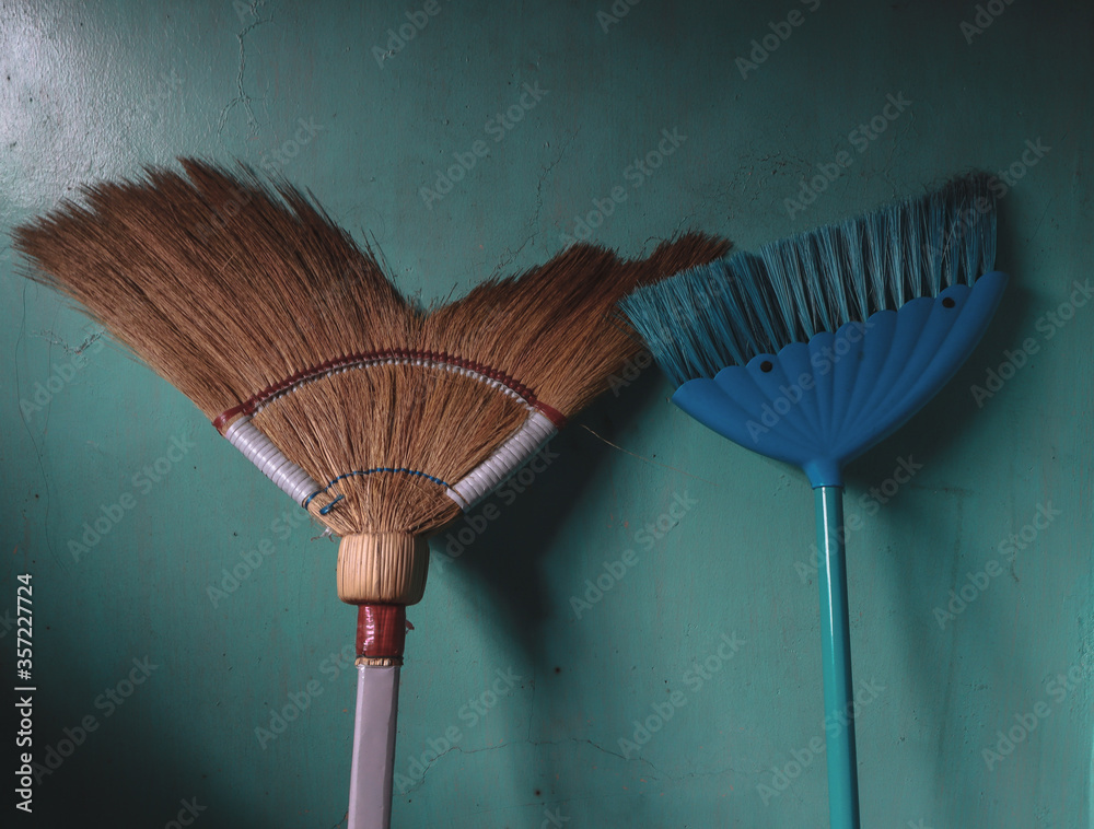 A traditional Filipino broom versus modern broom closely captured. Stock Photo Adobe Stock