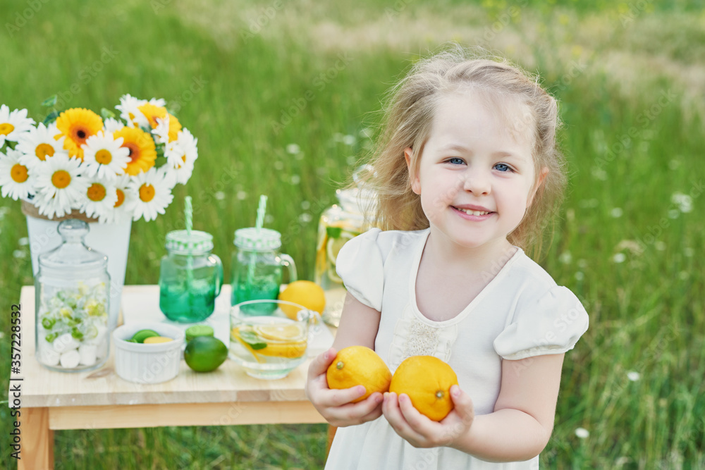 Child girl with lemonade. Lemonade and daisy flowers on table. Cozy morning. Spring and summer season card. Healthy Food and Drink. Summer holidays. Outdoor picnic. Mother's day card.