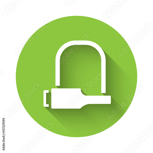 White Bicycle lock U shaped industrial icon isolated with long shadow. Green circle button. Vector Illustration.