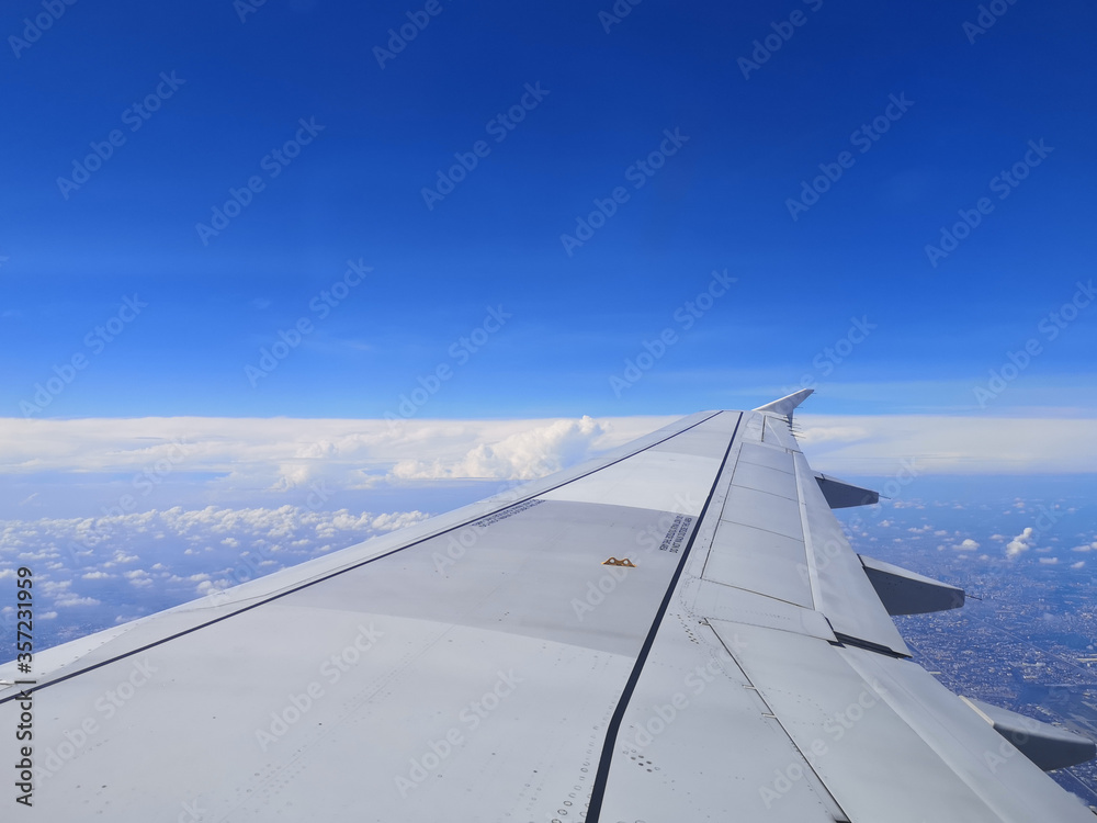 airplane wing in blue sky