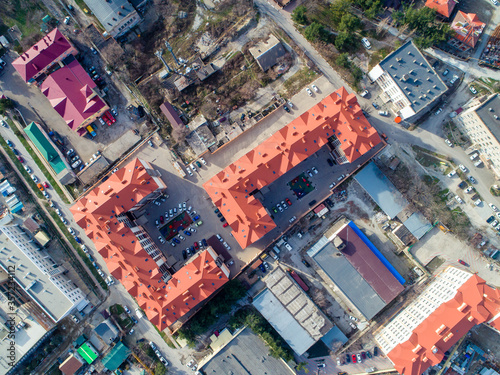 Residential complex of three multi-storey buildings with red roofs. The view from the top.