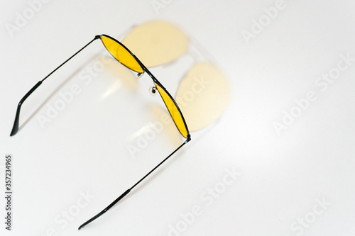 Yellow sun glasses isolated over the white background