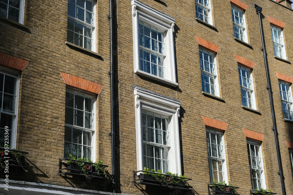 Sunlit brick buildings on a street in London