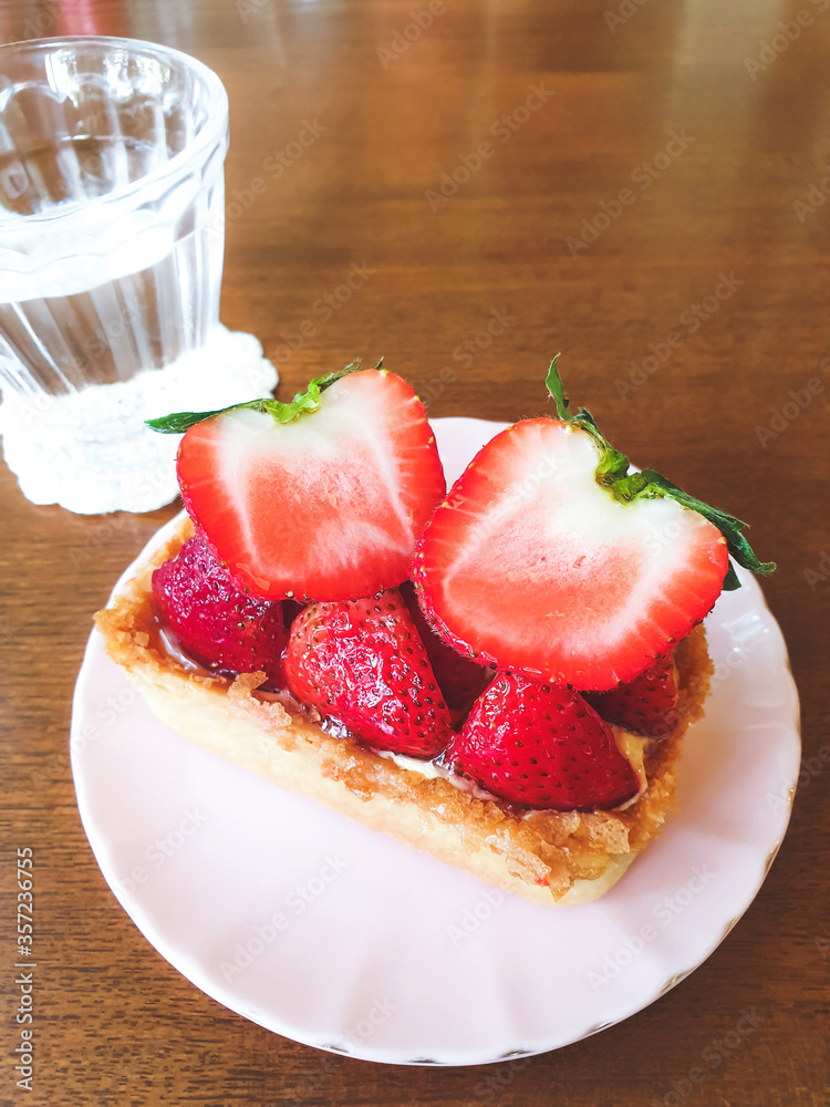 Strawberry Tart on a white plate, sweet dessert in afternoon coffee or tea Strawberry Tart on a white plate, sweet dessert in afternoon coffee or tea