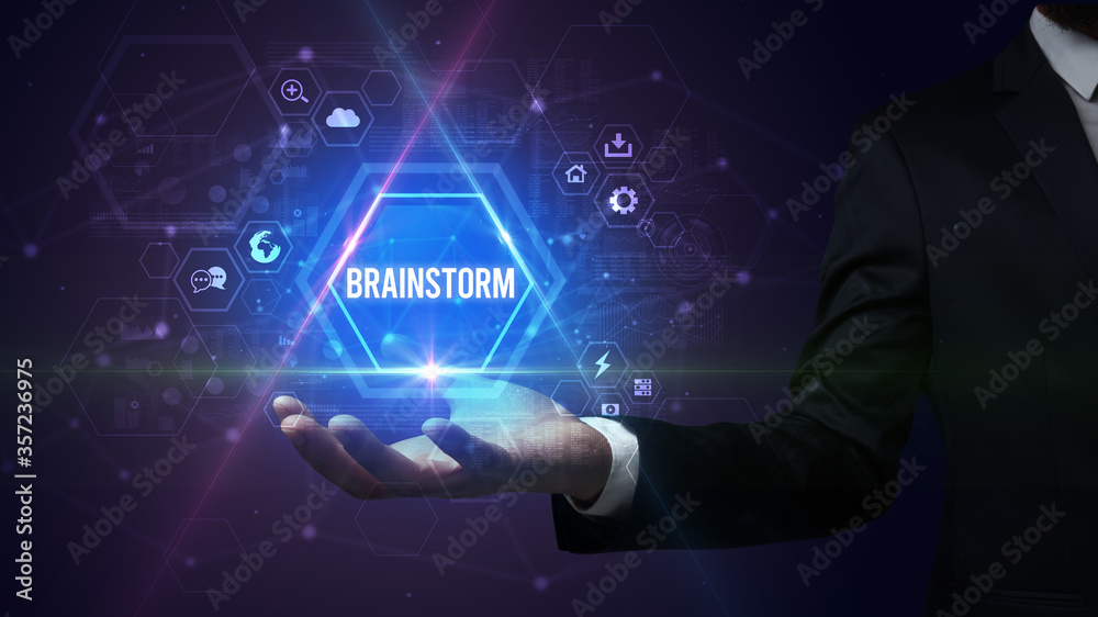 Man hand holding BRAINSTORM inscription, social media concept Man hand holding BRAINSTORM inscription, social media concept
