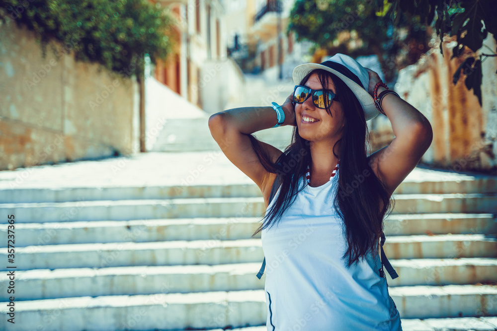 Happy traveler girl in Greek island of Symi, Dodecanese, Greece.
