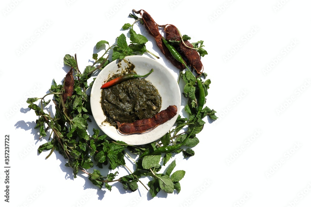Pudina Chutney or Field Mint Leaves Paste in a Plate with Raw