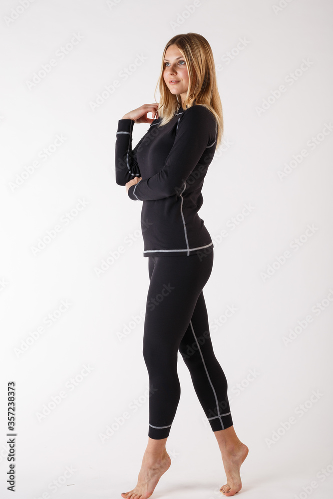 Girl in thermal underwear on a white background. Sportswear.