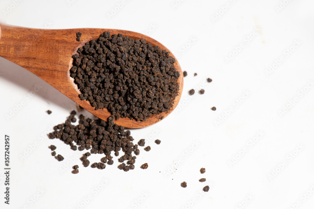 Dried Tea Leaves powder on Spoon With White Background Dried Tea Leaves powder on Spoon With White Background