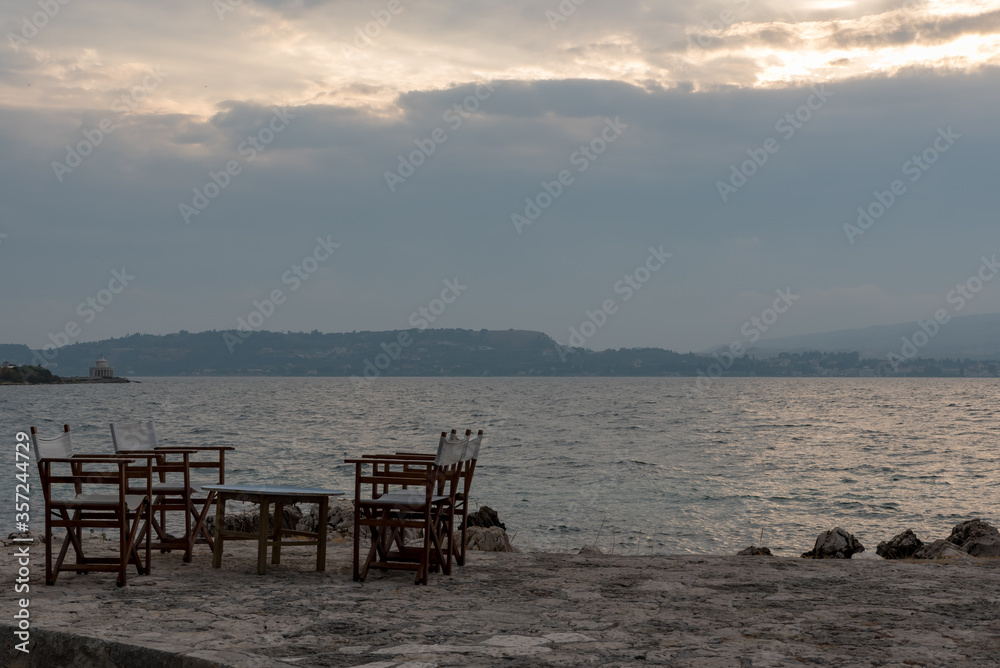 Small tables of a restaurant by the Greek sea Small tables of a restaurant by the Greek sea