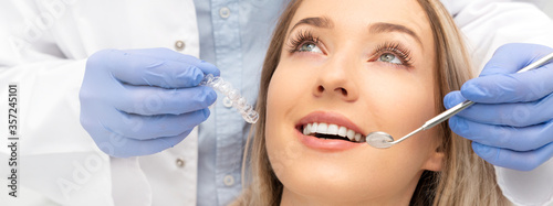 Woman having teeth examined at dentists