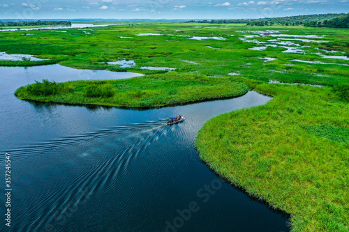 Dramatic landscape from above by the river, boat crossing in the wild African landscapes of Angola photo