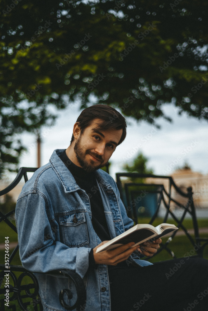 Fototapeta premium man reading a book in the park