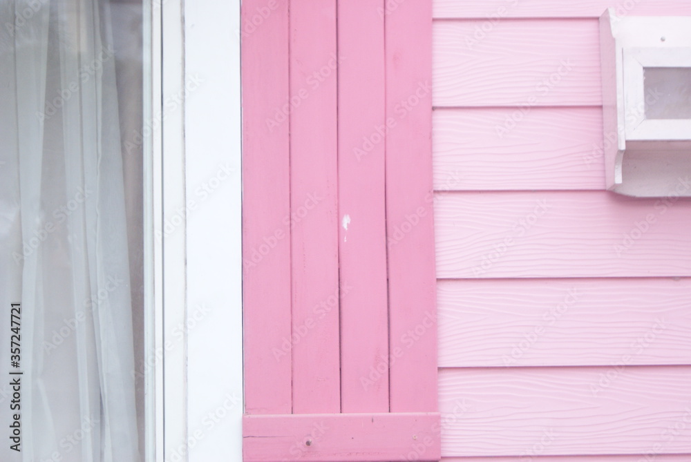 A colorful wooden house looks from the side