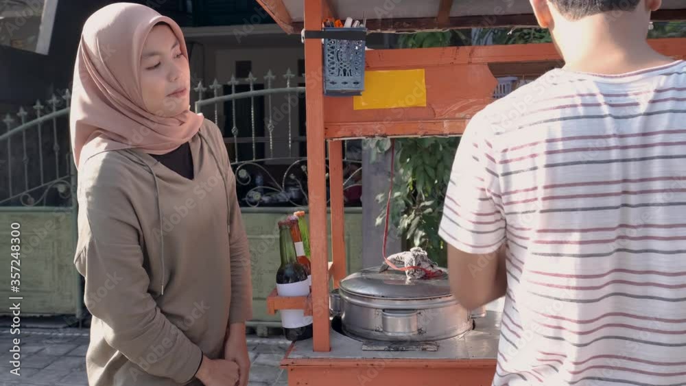 man selling bakso in the carts. indonesia street food. small business entrepreneur man selling bakso in the carts. indonesia street food. small business entrepreneur