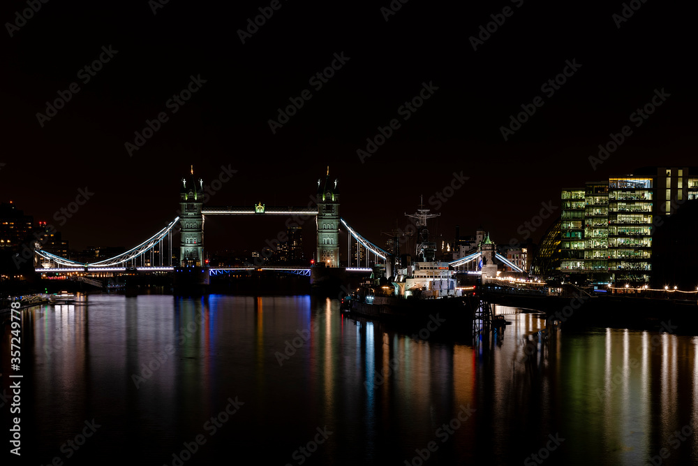 HMS Belfast floating on the river Thames next to Tower Bridge