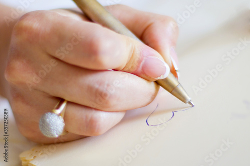 Woman writing love letter. Close up of woman hand writing love letter in diary with hope to her sweetheart romantic white background. Young woman or girl writing heart   message love letter for lover
