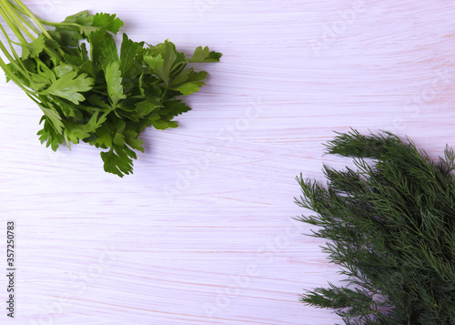 green grocery herbs on white wooden surface with space for text photo