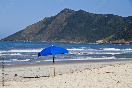 Seascape of a beach and an umbrella in Ãrea de ProteÃ§Ã£o Ambiental Bairro de Grumari Rio Brazil photo