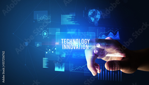 Hand touching TECHNOLOGY INNOVATION inscription, new business technology concept