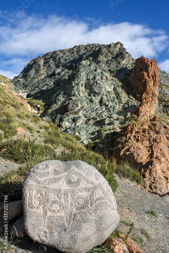 Carved colurful rocks on trekking kora around mountain Kailash Day 1 pilgrimage route near Darchen, Tibet, Asia